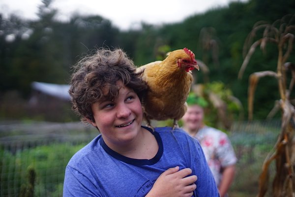 Boy with chicken on shoulder